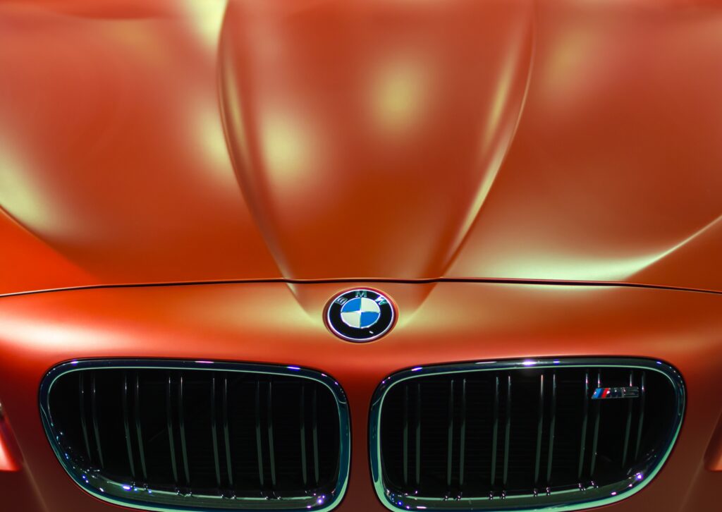 Fresh motor oil being poured into a vehicle engine during an oil change and routine maintenance 