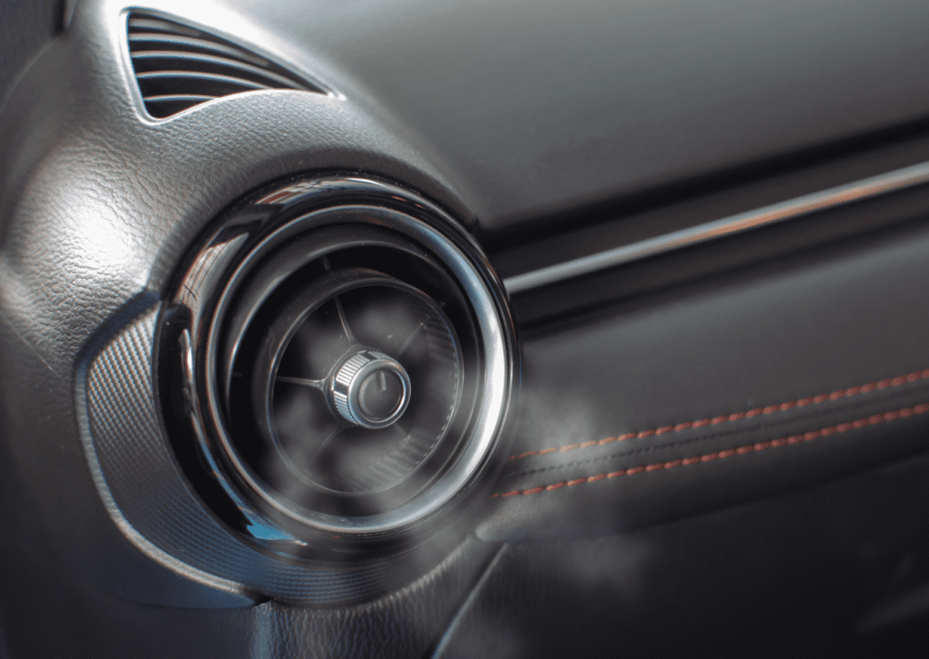 Close-up of cool air flowing from vehicle vent during car ac and climate control repair work 